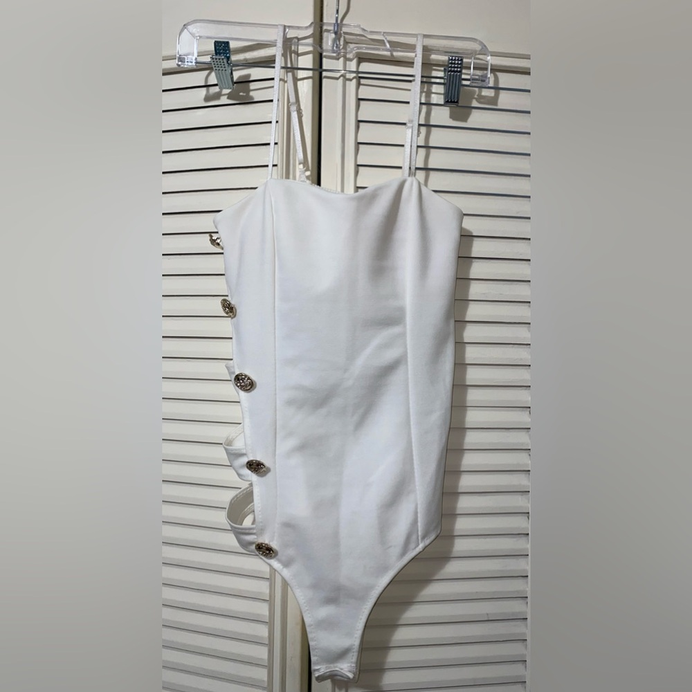 Elegant White bodysuit with Gold Buttons.
Never worn.
